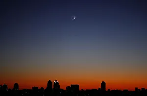A crescent moon is seen over Buenos Aires at sunrise A crescent moon is seen over Buenos Aires at sunrise
