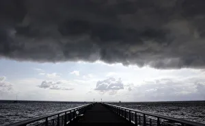 Dark clouds fill the Autumn sky over the jetty in Andernos, southwestern France Dark clouds fill the Autumn sky over the jetty in Andernos, southwestern France