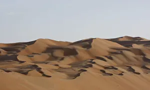 Dawn sunlight hits the dunes of the of Al Batin Near Liwa in the United Arab Emirates Dawn sunlight hits the dunes of the of Al Batin Near Liwa in the United Arab Emirates
