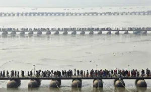 Devotees make their way across pontoon bridges spanning the Sangam during Magh Mela Devotees make their way across pontoon bridges spanning the Sangam during Magh Mela