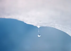 A drop of water falls from a melting piece of ice on Argentinas Perito Moreno glacier A drop of water falls from a melting piece of ice on Argentinas Perito Moreno glacier