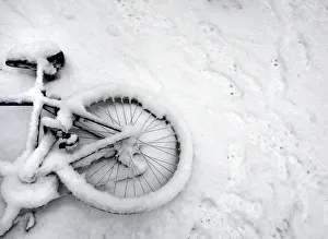 A fallen bicycle lies in the snow in Cambridge in eastern England A fallen bicycle lies in the snow in Cambridge in eastern England