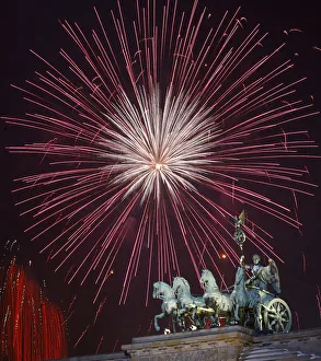 Fireworks explode above the Quadriga atop the Brandenburg Gate during New Year celebrations Fireworks explode above the Quadriga atop the Brandenburg Gate during New Year celebrations