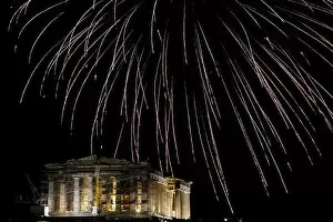 Images Dated 31st December 2015: Fireworks explode over the temple of the Parthenon atop Acropolis hill during New Year s
