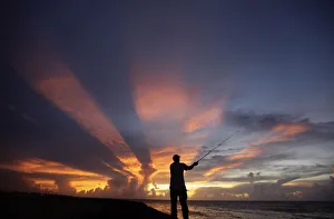 A fisherman casts his line as the sun sets on the outskirts of Havana A fisherman casts his line as the sun sets on the outskirts of Havana