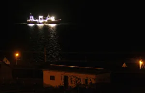 A fishing ship is seen at night along the coast of Port Stanley A fishing ship is seen at night along the coast of Port Stanley