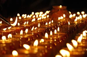 Images Dated 6th June 2010: A follower lights a candle during The Grand Anniversary Memorial Prayer of Lord Jigten