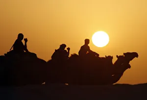 Foreign tourists ride camels near Dakhla oasis in Egypts Western Desert, some 900 Foreign tourists ride camels near Dakhla oasis in Egypts Western Desert, some 900