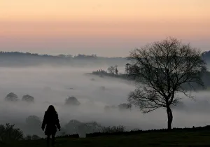 A girl looks out over fog covered Leicestershire countryside A girl looks out over fog covered Leicestershire countryside