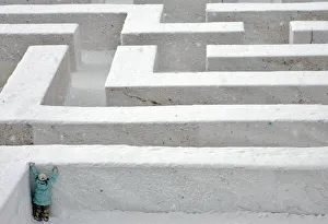 A girl tries to climb a snow-packed wall in a labyrinth at the Sapporo Snow Festival A girl tries to climb a snow-packed wall in a labyrinth at the Sapporo Snow Festival