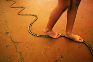 A girls walks on a rope on the floor during a circus workshop in a Caracas neighborhood A girls walks on a rope on the floor during a circus workshop in a Caracas neighborhood