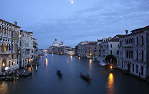 Gondoliers row in an empty Grand Canal in Venice Gondoliers row in an empty Grand Canal in Venice