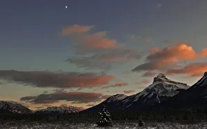 A half moon sits over Moose Meadow at sunset in Banff National Park near Lake Louise A half moon sits over Moose Meadow at sunset in Banff National Park near Lake Louise