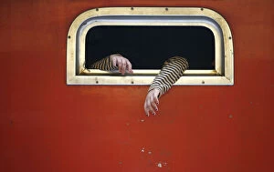 Images Dated 8th October 2007: The hands of a passenger on board a train are pictured at the train station in Jakarta