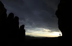 Hiker rounds Cathedral Rock at sun set in Sedona, Arizona Hiker rounds Cathedral Rock at sun set in Sedona, Arizona