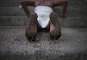 A Hindu devotees feet are seen while he rolls on the ground during the first day of A Hindu devotees feet are seen while he rolls on the ground during the first day of