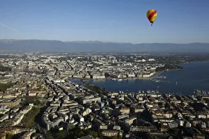 A hot air balloon flies above the city of Geneva A hot air balloon flies above the city of Geneva