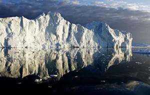 Icebergs are reflected in the calm waters at the mouth of the Jakobshavn ice fjord Icebergs are reflected in the calm waters at the mouth of the Jakobshavn ice fjord
