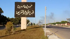 Still image of an Arabic sign with smoke rising in background as forces aligned with Still image of an Arabic sign with smoke rising in background as forces aligned with