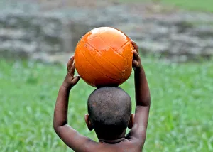 An Indian child plays with a basketball in a field in the eastern Indian city of Calcutta An Indian child plays with a basketball in a field in the eastern Indian city of Calcutta