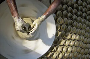 An Indian potter makes earthen lamps at his workplace in Lucknow An Indian potter makes earthen lamps at his workplace in Lucknow