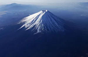 Japans Mount Fuji is seen covered with snow from an airplane Japans Mount Fuji is seen covered with snow from an airplane