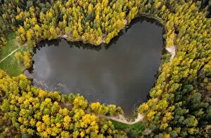 Russia Collection: A lake in a shape of a heart is seen surrounded by autumn-coloured trees outside