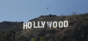 Images Dated 22nd February 2014: A LAPD helicopter flies over the Hollywood sign in Hollywood