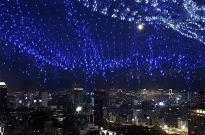 A light display of the Milky Way is reflected on a window as skyscrapers and the Tokyo A light display of the Milky Way is reflected on a window as skyscrapers and the Tokyo