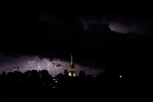 Lightning illuminates the sky above the Muenster Cathedral in Bern Lightning illuminates the sky above the Muenster Cathedral in Bern