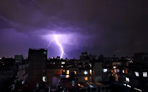 Lightning strikes over buildings during a thunderstorm in Kathmandu Lightning strikes over buildings during a thunderstorm in Kathmandu