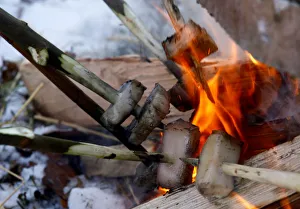 Local residents put pig fat in a camp fire during the celebrations of Kolyada pagan Local residents put pig fat in a camp fire during the celebrations of Kolyada pagan