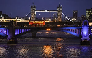Images Dated 18th December 2013: A London bus crosses the River Thames on London Bridge during the evening rush hour