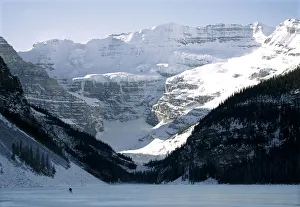 A lone hockey player skates on frozen Lake Louise in Canadas Banff National Park A lone hockey player skates on frozen Lake Louise in Canadas Banff National Park