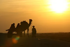 A man with his camel cart is silhouetted at Jaisalmer A man with his camel cart is silhouetted at Jaisalmer