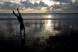 A man does a handstand on Kuta beach on the Indonesian resort island of Bali A man does a handstand on Kuta beach on the Indonesian resort island of Bali