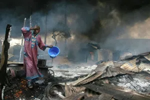 A man rinses soot from his face, Lagos 2006 A man rinses soot from his face, Lagos 2006