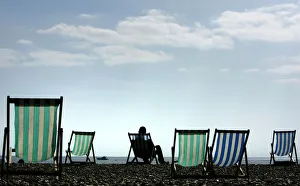 A man sits on a deck chair in warm Easter weather on Brighton beach in southern England A man sits on a deck chair in warm Easter weather on Brighton beach in southern England