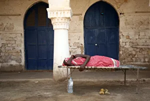 A man sleeps outdoors in the port city of Massawa A man sleeps outdoors in the port city of Massawa
