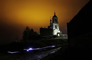 A man uses a torch as he leaves a church after an Orthodox Easter night mass in the A man uses a torch as he leaves a church after an Orthodox Easter night mass in the