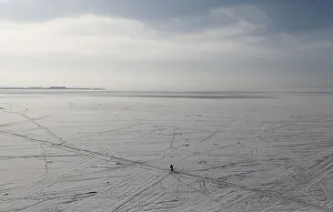 A man walks on the ice-covered Gulf of Finland in St. Petersburg A man walks on the ice-covered Gulf of Finland in St. Petersburg