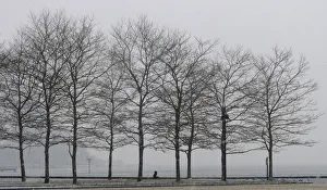 A man walks in a park along the Hudson River across from Manhattan in Hoboken, New Jersey A man walks in a park along the Hudson River across from Manhattan in Hoboken, New Jersey