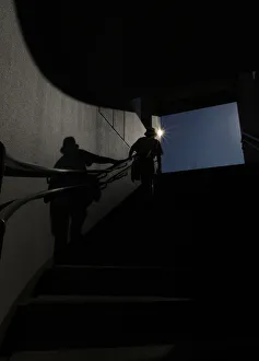 A man walks up a stairs at an entrance of an underway passage of a railway station at a A man walks up a stairs at an entrance of an underway passage of a railway station at a