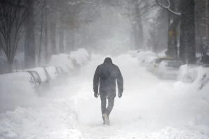 Images Dated 23rd January 2016: A man walks along a street covered by snow during a winter storm in Washington