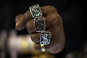A man wears dollar sign rings in a jewellery shop in Manhattan in New York City A man wears dollar sign rings in a jewellery shop in Manhattan in New York City