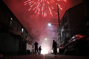 Men light up fireworks as residents celebrate the start of the Chinese New Year in Men light up fireworks as residents celebrate the start of the Chinese New Year in