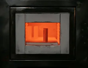A mold for forming gold bars is kept at high-temperature in an oven at a Tanaka Kikinzoku A mold for forming gold bars is kept at high-temperature in an oven at a Tanaka Kikinzoku