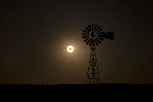 The moon passes between the sun and the earth behind a windmill near Albuquerque The moon passes between the sun and the earth behind a windmill near Albuquerque