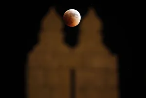 The moon is seen behind the wall of Damascus gate in Jerusalem Old City during a total The moon is seen behind the wall of Damascus gate in Jerusalem Old City during a total