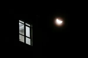 Prints of The light shines in the window of a building during a partial lunar eclipse in Yevpatoriya, Crimea July 17, 2019. REUTERS/Alexey Pavlishak Eclipse Prints: Partial Lunar Eclipse Print